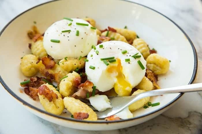 Gnocchi for breakfast? Why not? This Gnocchi Breakfast Skillet is perfect for leftover gnocchi - make sure to make extra gnocchi the night before so you can make this for breakfast the next day!! From @kitchenmagpie #recipe #breakfast #eggs #bacon 