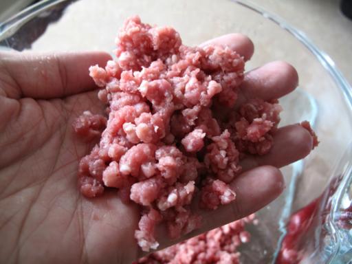 close up of the ground beef created by grinder attached to mixer