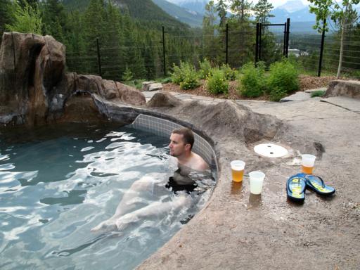 a man at the hot tubs with mountain view background