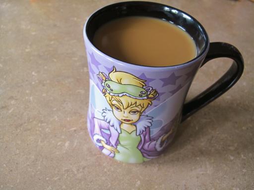 close up of a cup of coffee in Tinkerbell mug