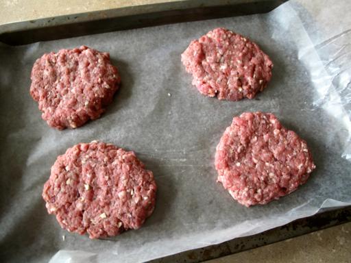 mixed ingredients in a form of burger patties placed in parchment paper
