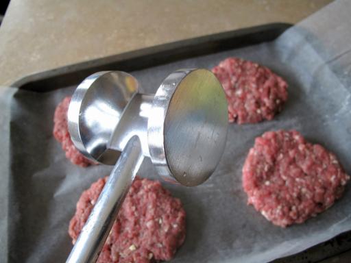 round kitchen mallet to shape and flatten the burger patties