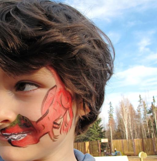 kid's face with an alligator paint