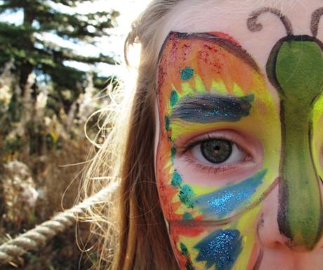 kid's face with butterfly paint