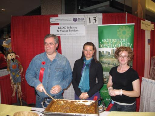 the EEDC Industry & Visitor Services Booth, A man with two ladies wearing black