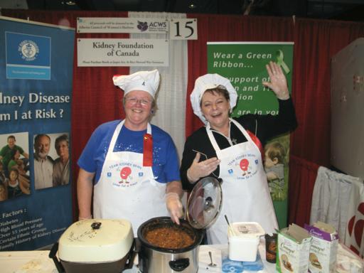 booth of the Kidney Foundation with two women wearing white kitchen aprons and hair cap