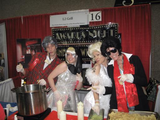 the L2 Grill booth with two ladies wearing white dresses and two men in their sides wearing black and red