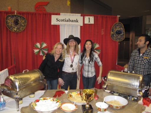 girl's group picture at Scotiabank booth with red curtain on background