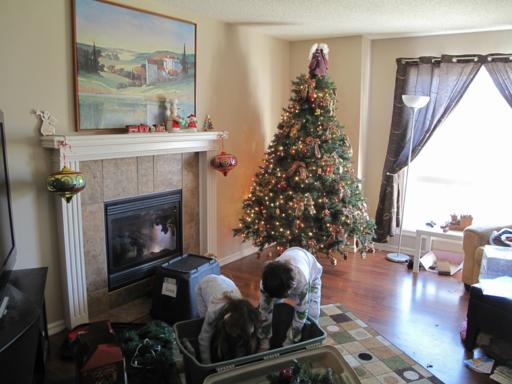 two kids busy retrieving the Christmas decors from the box