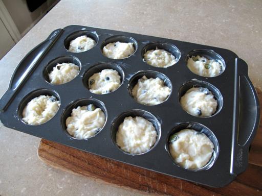 muffin tins filled with lemon blueberry dough