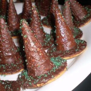 close up of witches hats - chocolate covered digestive cookies and mini cones for the top