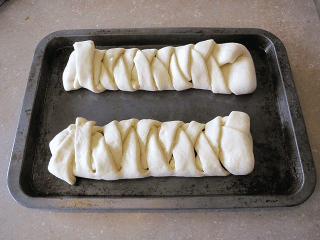 Folded dough on two fruit bread braids completed and ready to bake 