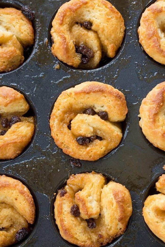 close up of Cinnamon Buns with raisins in muffin tins