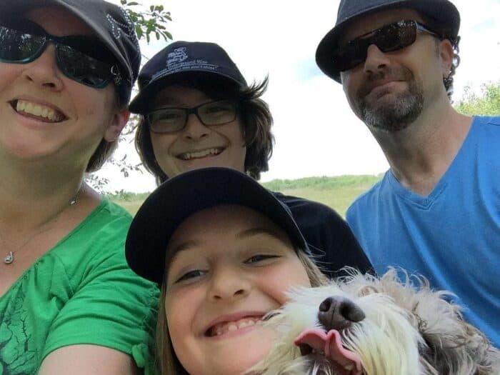 family selfie picture with a dog, everyone is smiling