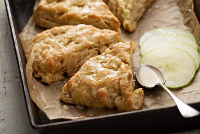 glazed pie shape Apple Scones with slices of tart apples on side