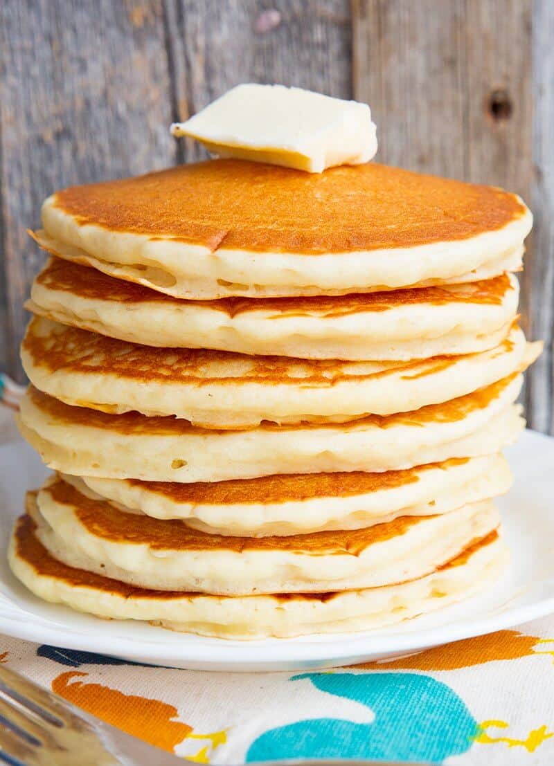 Close up stack of pancakes with butter on top