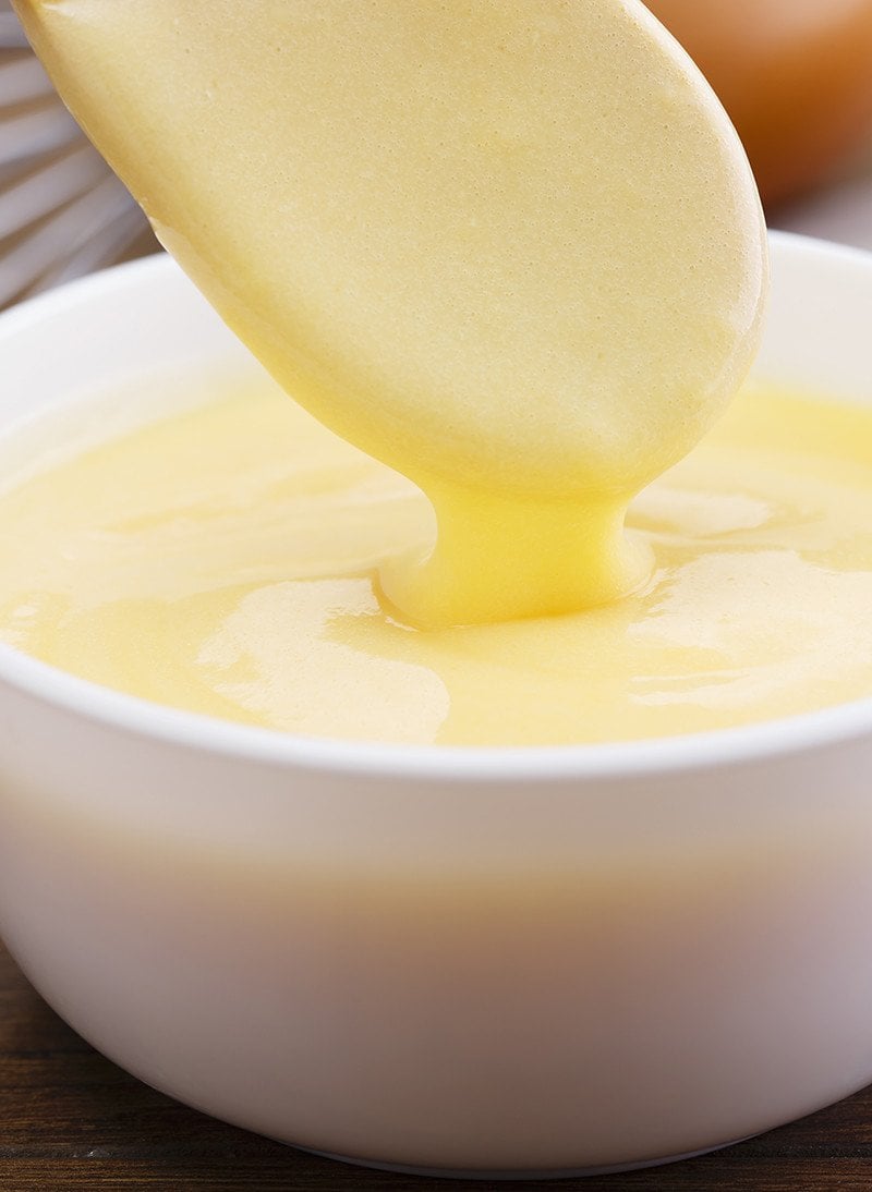 close up buttery Blender Hollandaise Sauce in a white dipping bowl