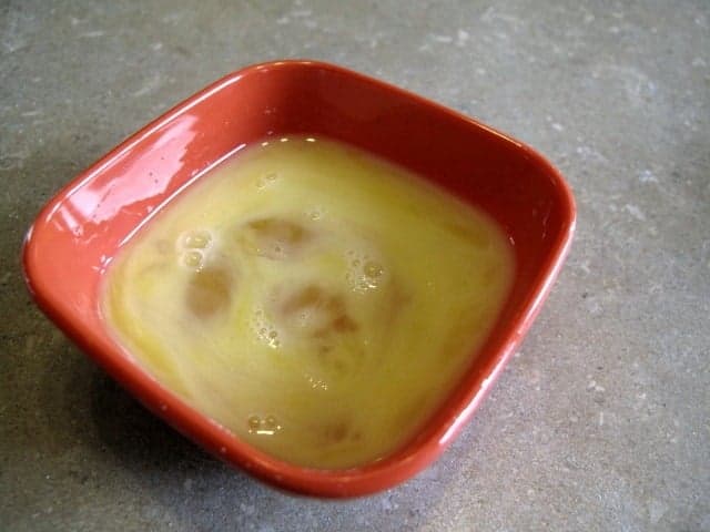  beaten egg in a small red bowl