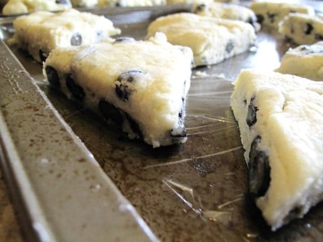 little pie-like pieces of scones on a baking sheet