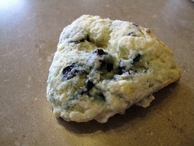a piece of a pie-like baked blueberry scone