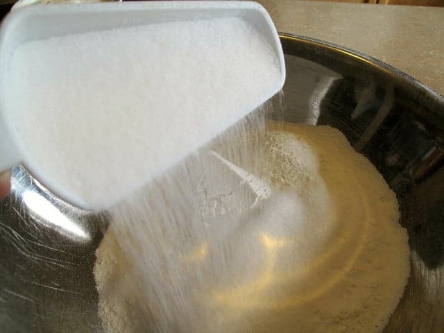 adding a cup of sugar to the flour mixture for scones recipe