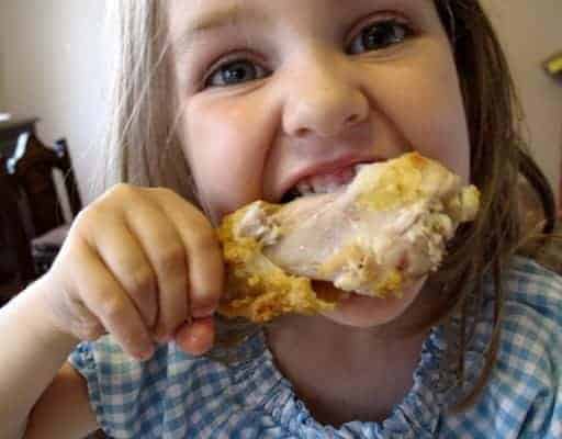 little girl enjoying the Crispy Oven Fried Chicken