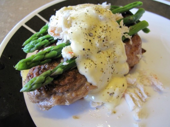 Steak Oscar in a plate with asparagus and white sauce