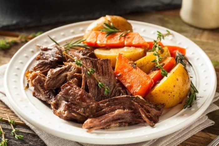 Beef Coca Cola Pot Roast with chopped vegetables on a white plate