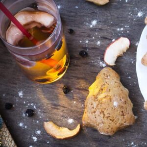 top down shot of ginger tea and scones in cute little tree shape on wood background
