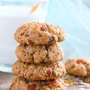 stack of Spicy Oatmeal Raisin Cookies with a glass of milk on background