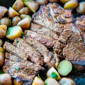 sliced Marinated then Barbecued T-Bone steak with sliced mini potatoes