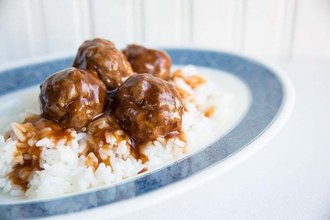 plate with rice topped with Sweet and Sour Meatballs