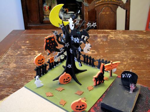 miniature of spooky tree with moon, pumpkins and coffin