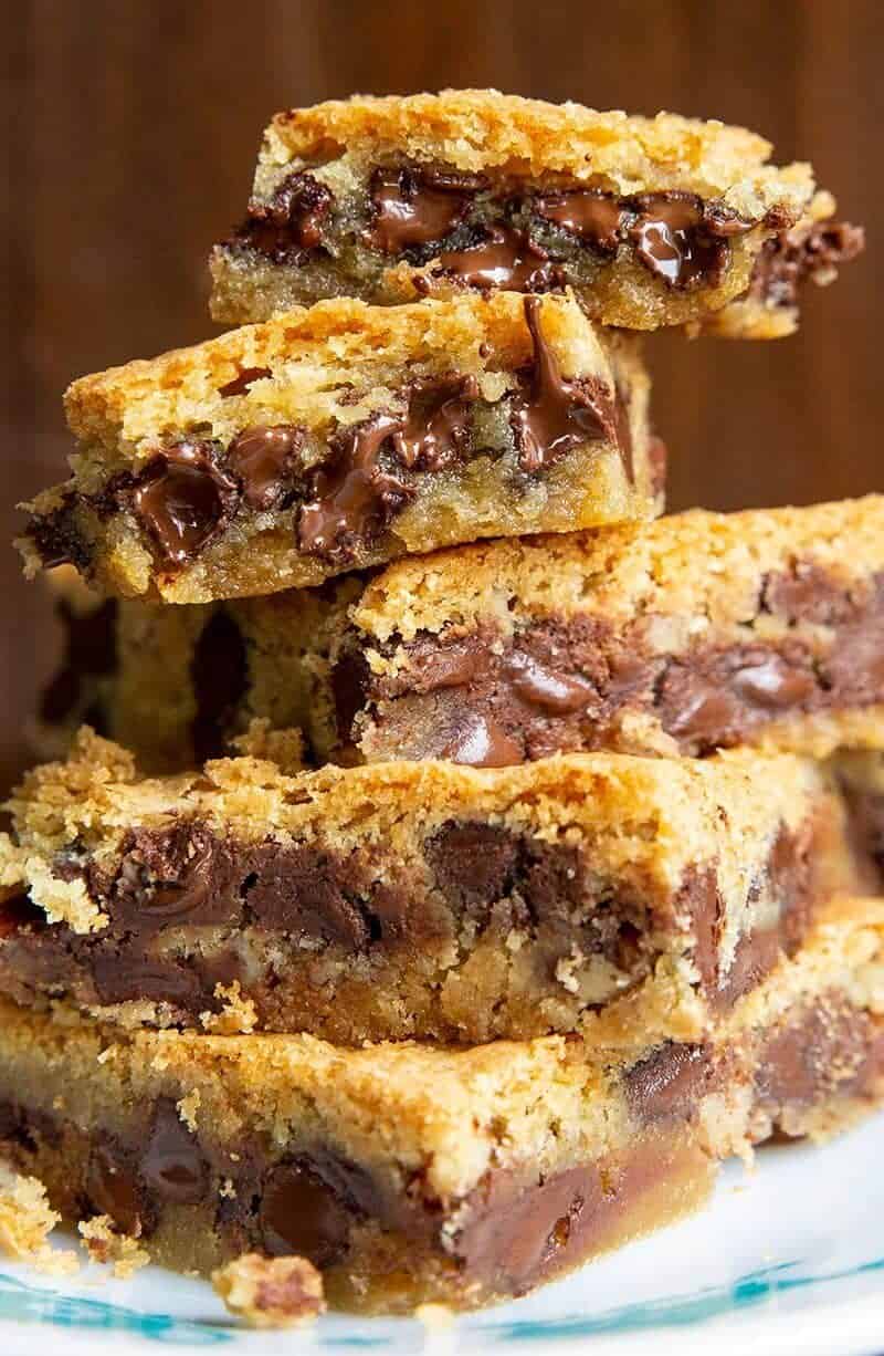  close up stack of Chocolate Chip Cookie Bars on a white and blue plate