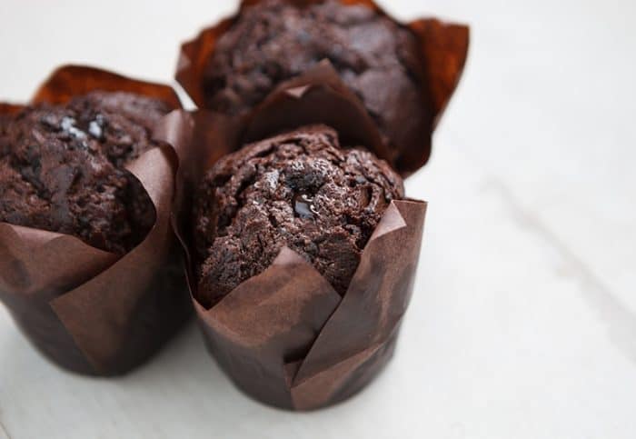 3 pieces Chocolate Zucchini Cupcakes with melted chocolate drizzled on top 