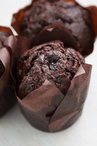 close up Chocolate Zucchini Cupcakes with brown cupcake liners on white background