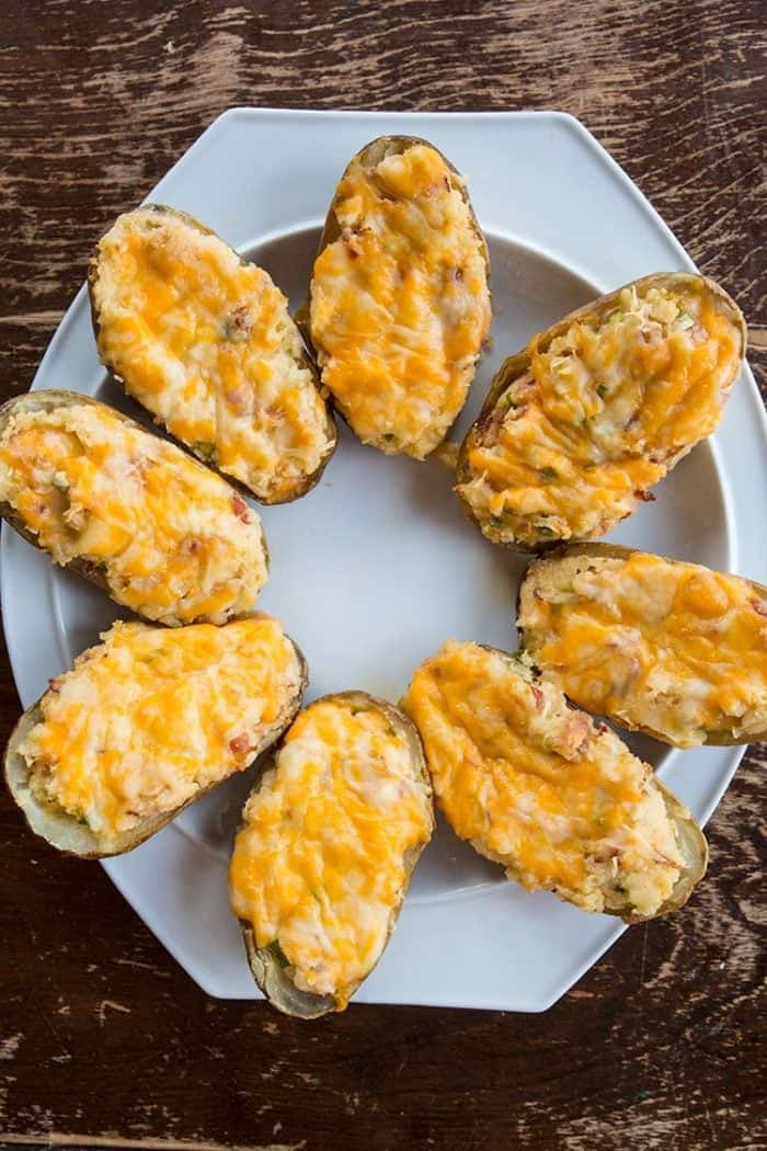 8 pieces of Twice baked potatoes on a white plate