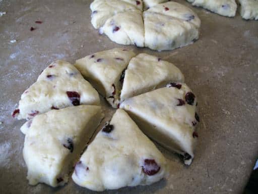 Lemon Cranberry Scones dough flatten into 6 inch disks then Cut each piece in 6 triangles