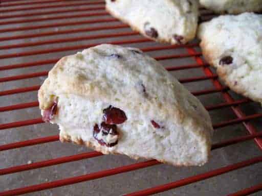 pieces of Lemon Cranberry Scones in a red cooling rack