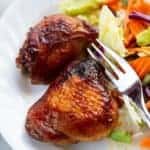 baked Teriyaki Chicken on a white plate with a fork and some vegetables