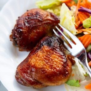 baked Teriyaki Chicken on a white plate with a fork and some vegetables