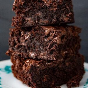 close up stack of Fudgy Brownie slices in a white dessert plate