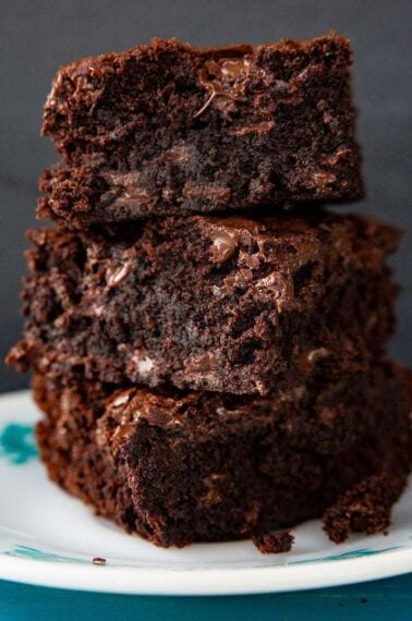 close up stack of Fudgy Brownie slices in a white dessert plate