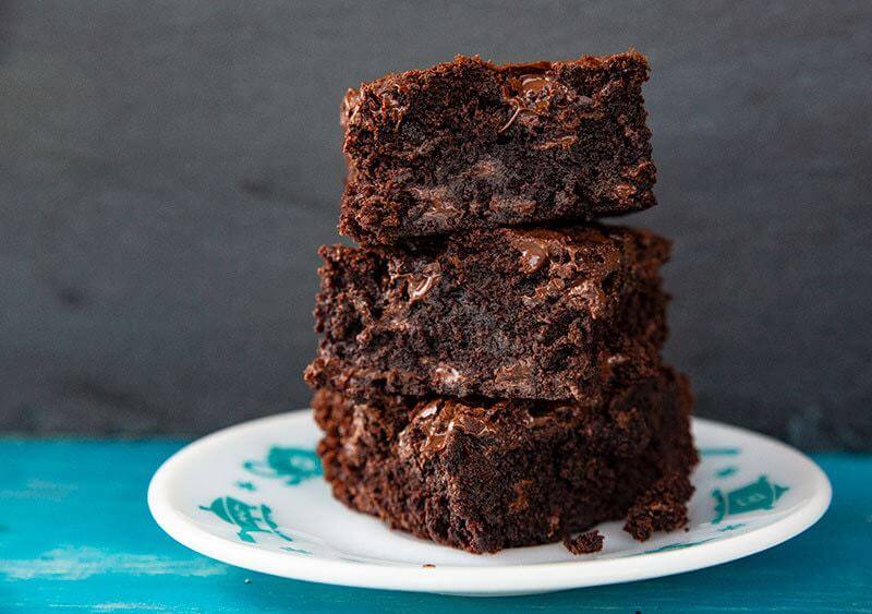 stack of Fudgy Brownie slices in a white dessert plate