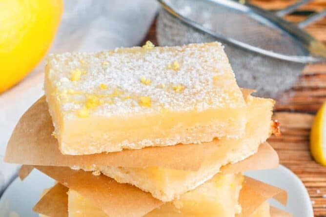 stack of Creamy Lemon Bar slices with shortbread crust