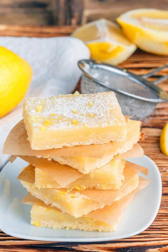 stack of Creamy Lemon Bar slices with shortbread crust