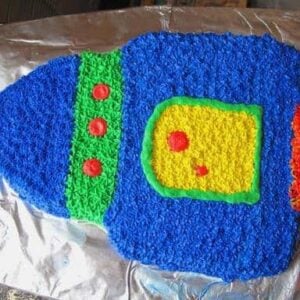 blue, green, red and yellow desiged rocket birthday cake