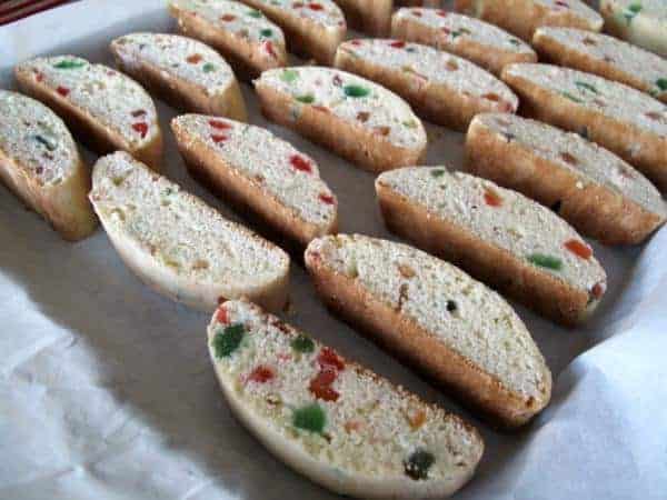 sliced baked Christmas Biscotti in baking sheet with parchment paper