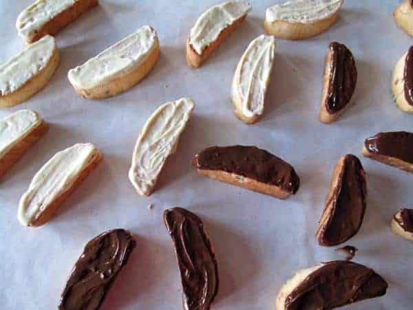 slices of baked Christmas Biscotti with sides dipped into chocolates