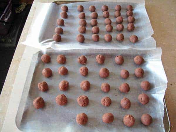 chocolate truffles on tray with waxed paper